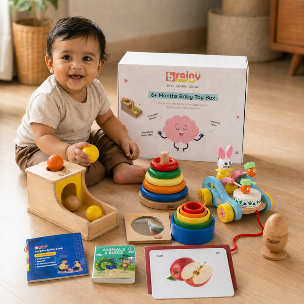 Baby sitting with the BrainyTots 6+ Months Baby Toy Box and its wooden toys