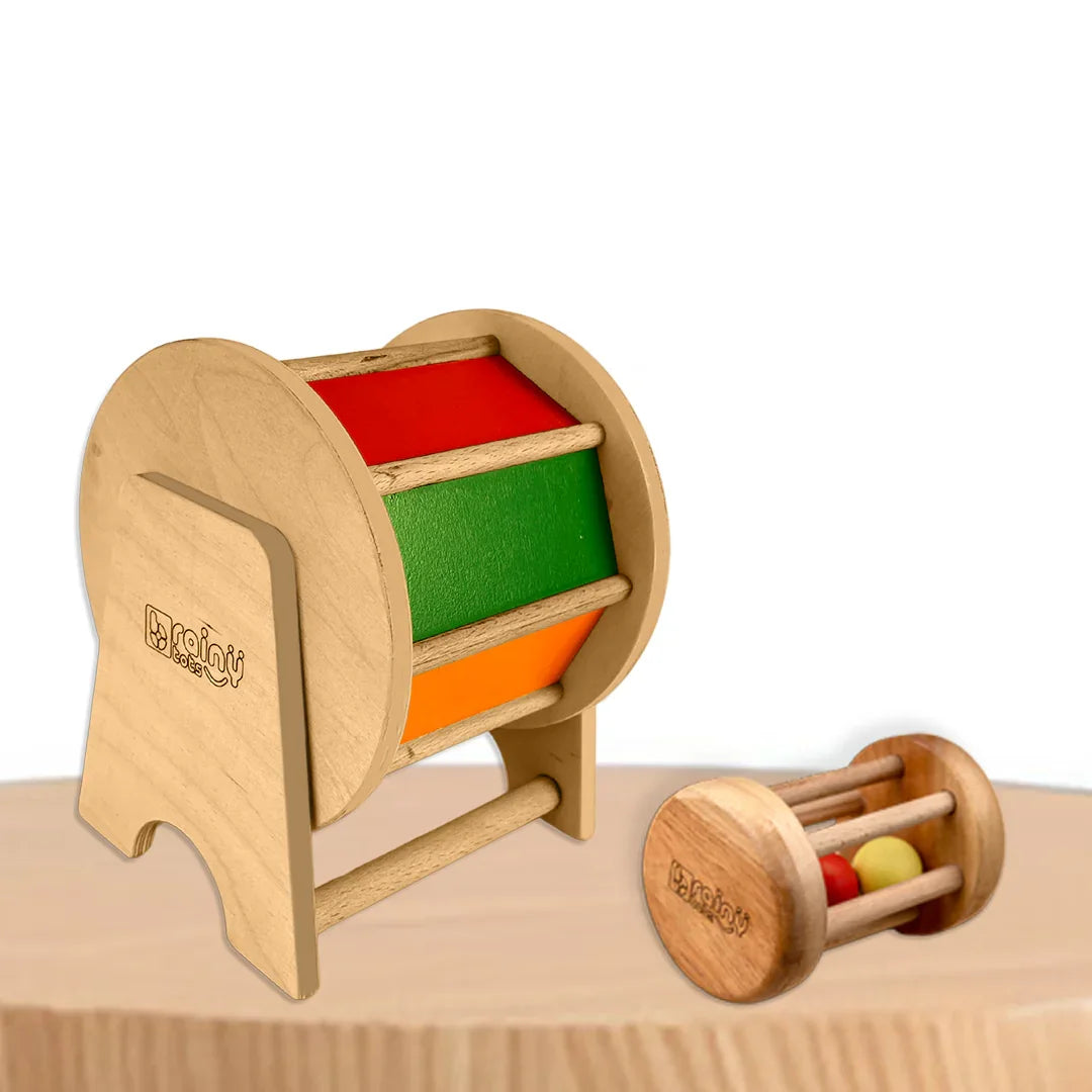 BrainyTots Baby Crawling Combo featuring the Rainbow Spinning Wheel and Neem Wood Rolling Drum Rattle for babies aged 3+ months. This Montessori-inspired tummy time toy set encourages crawling, strengthens core muscles, improves hand-eye coordination, provides gentle auditory stimulation, and supports sensory, gross motor, and fine motor development through self-guided play.