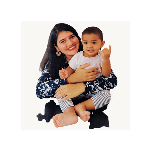 Nikita Aakhade, Founder of BrainyTots, holding her daughter and representing the brand's commitment to early learning and purposeful play.