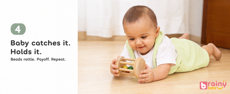 Baby catches it. Holds it.