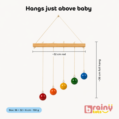 Wooden baby mobile with colorful hanging balls and dimensions on a white background, branded 'Brainytots'.