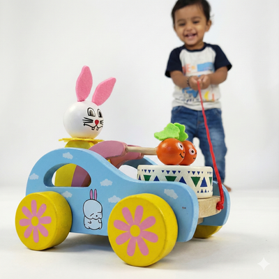 Toddler pulling the BrainyTots Wooden Pull Toy to encourage walking, gross motor development, whole body coordination, and cause-and-effect learning through Montessori-inspired play.