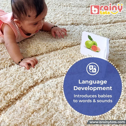Baby exploring a colorful board book during tummy time, encouraging language development, early vocabulary, visual attention, and word recognition through picture-based learning and interactive reading with parents.