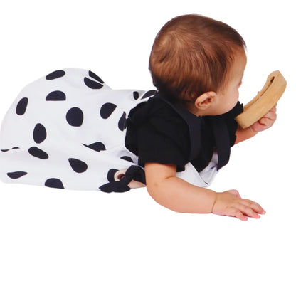 Baby holding and exploring the BrainyTots Montessori Banana Busy Beads Rattle during tummy time, encouraging grasping, hand-eye coordination, and sensory exploration.
