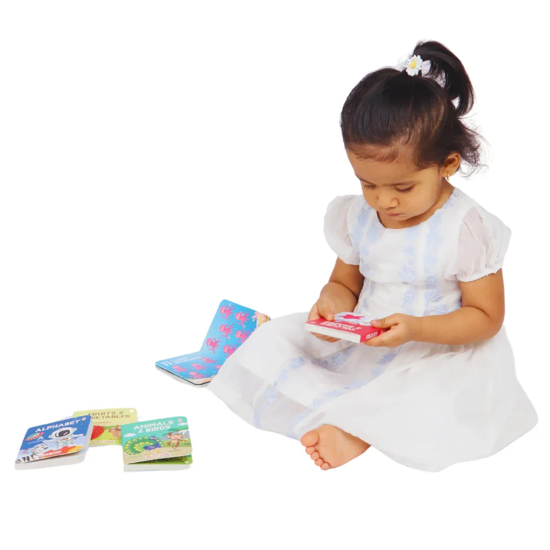 Child exploring the BrainyTots Board Books Set of 4 through independent reading, building vocabulary, fine motor skills, language development, and a love for books with Montessori-inspired learning.