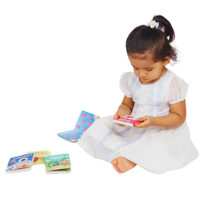 Child exploring the BrainyTots Board Books Set of 4 through independent reading, building vocabulary, fine motor skills, language development, and a love for books with Montessori-inspired learning.
