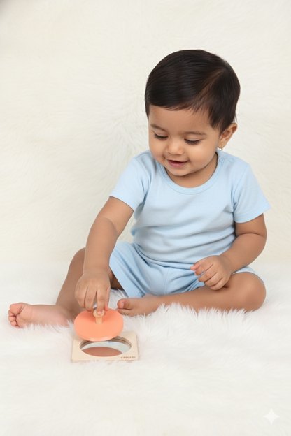 Baby playing with the BrainyTots wooden Circle Shape Puzzle, lifting the circular piece by its knob during hands-on Montessori play.