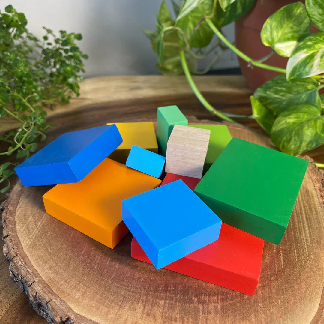 Individual pieces of the BrainyTots Montessori Geometric Rainbow Blocks – Shape & Balance Building Set for toddlers aged 24+ months. This colorful wooden block set includes multiple geometric shapes and sizes that encourage stacking, balancing, spatial awareness, creativity, problem-solving, and fine motor skill development through open-ended Montessori play.