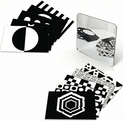 BrainyTots high contrast black and white flashcards with a baby-safe mirror for newborn visual play.