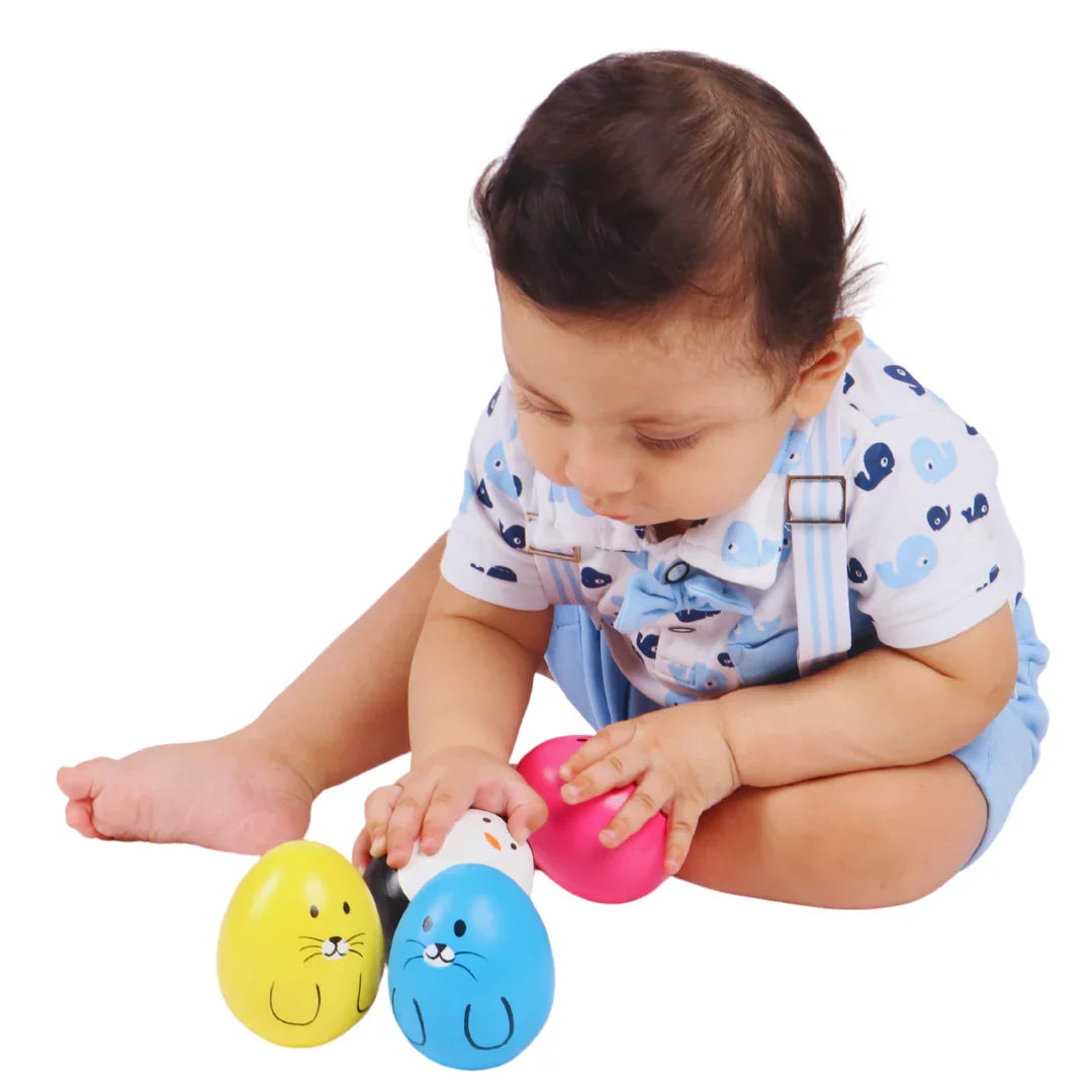 Baby grasping the BrainyTots Montessori Balancing Wobbler during independent play, encouraging fine motor skills, hand-eye coordination, sensory exploration, and cause-and-effect learning for babies 0–12 months.
