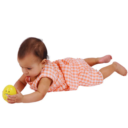 Baby grasping the BrainyTots Montessori Balancing Wobbler during tummy time, strengthening neck and core muscles while developing grasping skills, sensory exploration, and early motor development for babies 0–12 months.