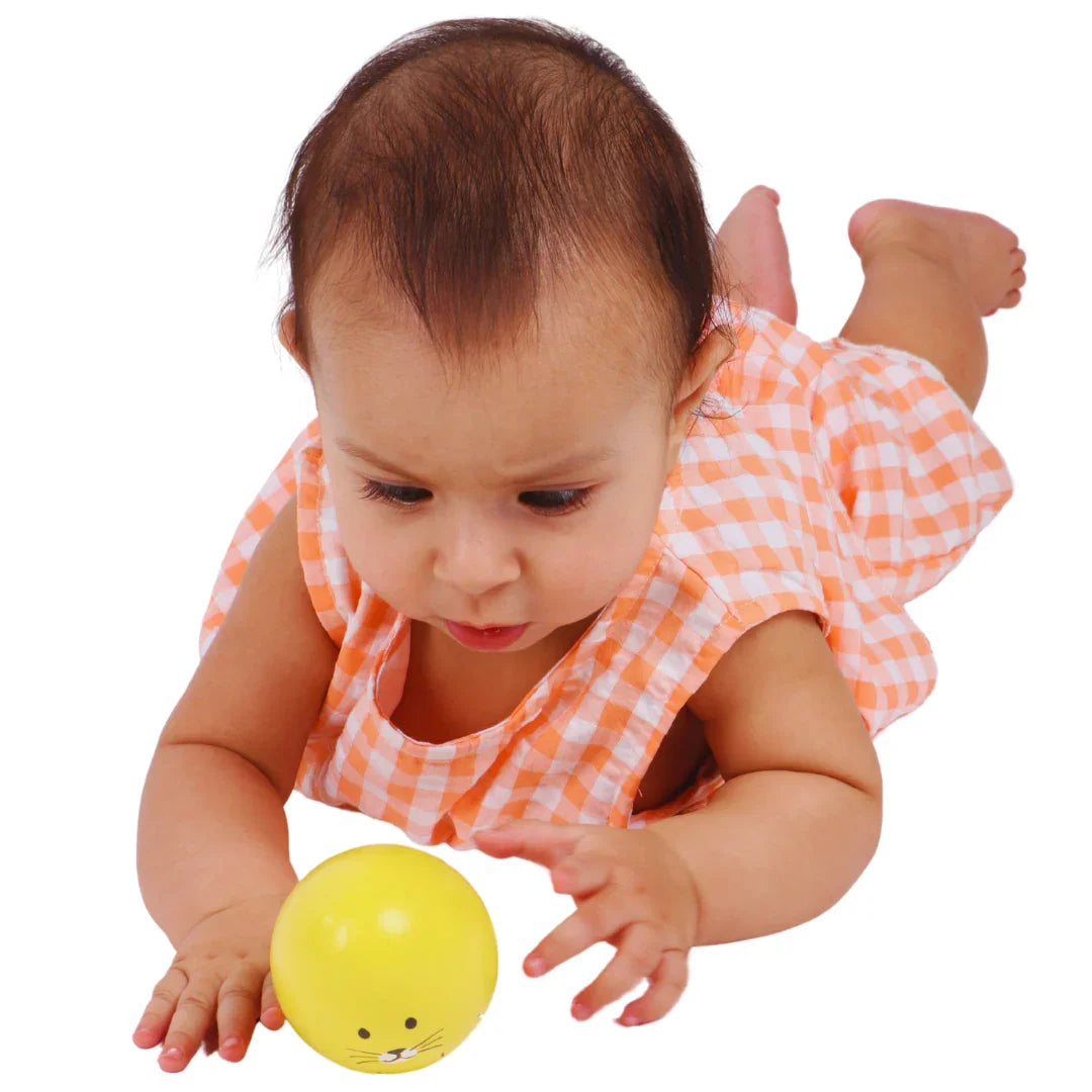 Baby reaching for the BrainyTots Montessori Balancing Wobbler during tummy time, encouraging reaching skills, visual tracking, core strength, and early motor development for babies 0–12 months.