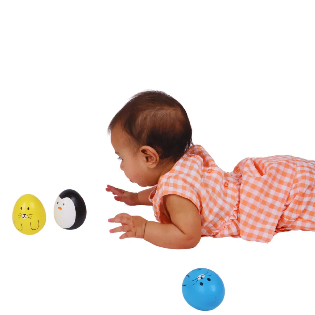 Baby reaching toward the BrainyTots Montessori Balancing Wobbler during tummy time, encouraging visual tracking, reaching skills, core strength, and early motor development for babies 0–12 months.