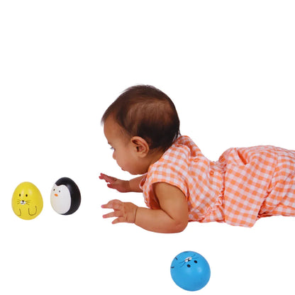 Baby reaching toward the BrainyTots Montessori Balancing Wobbler during tummy time, encouraging visual tracking, reaching skills, core strength, and early motor development for babies 0–12 months.