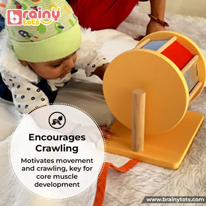Baby playing with the BrainyTots Rainbow Spinning Wheel during tummy time, encouraging crawling, gross motor development, hand-eye coordination, sensory exploration, and Montessori-inspired learning.