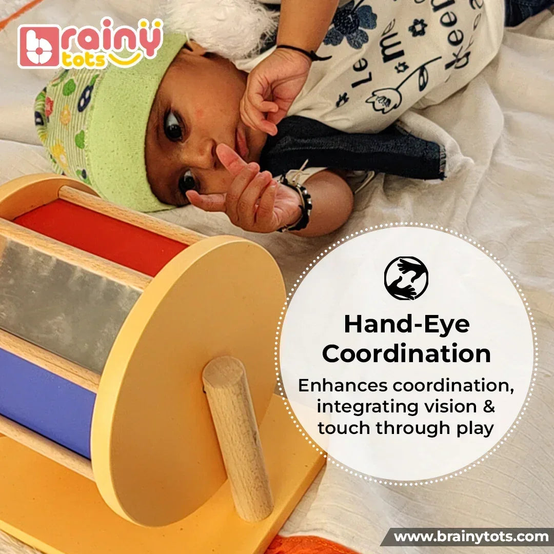 Baby exploring the BrainyTots Rainbow Spinning Wheel Montessori toy during tummy time, supporting hand-eye coordination, visual tracking, sensory exploration, and early motor skill development through interactive play.