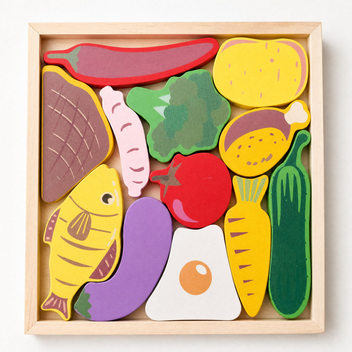 BrainyTots Montessori-inspired wooden food puzzle with 12 colorful miniature food pieces arranged in a square tray.