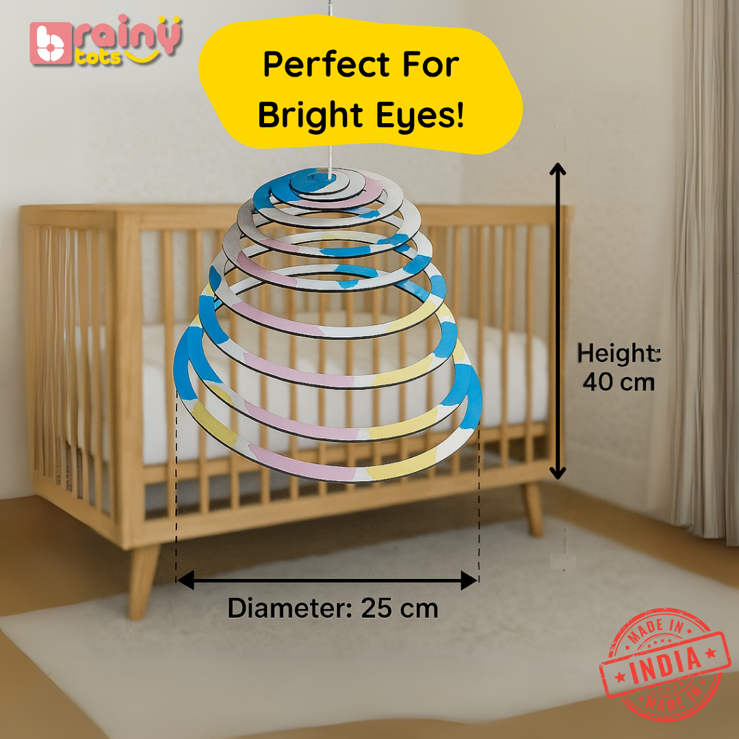 BrainyTots Spiral Hanging Mobile displayed above a baby crib with actual dimensions of 40 cm height and 25 cm diameter. This Montessori-inspired natural wooden baby mobile provides an engaging visual focal point that supports visual tracking, focus, concentration, and sensory development for newborns and babies aged 0–12 months.