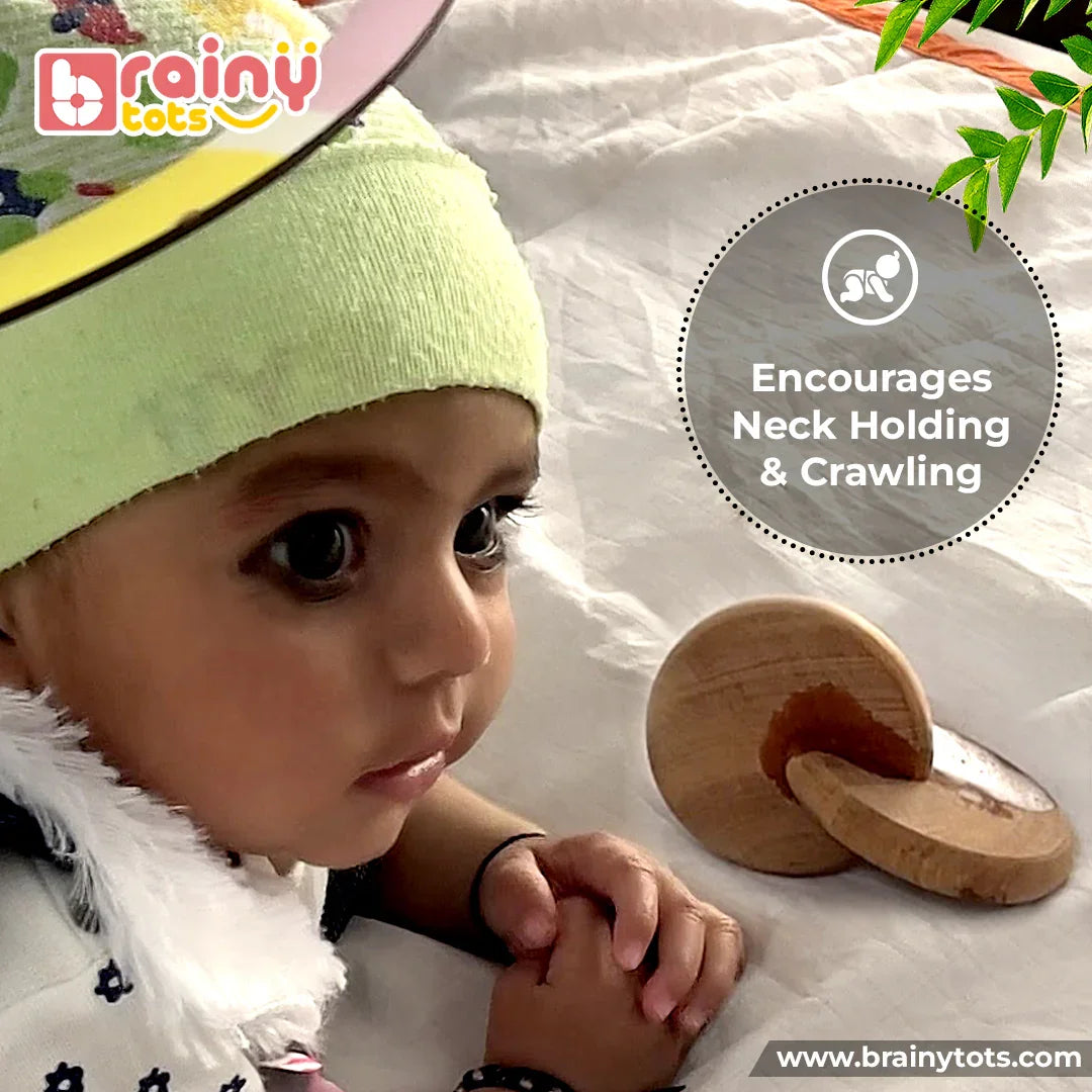 Baby playing during tummy time with BrainyTots Neem Wood Rolling Drum Rattle from the Montessori Neem Wood Teether Gift Set, encouraging neck holding, crawling, sensory development, and early motor skills for newborn babies.