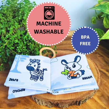 BrainyTots Montessori High-Contrast Cloth Book – Early Seeing & Calm Play Book with machine-washable, BPA-free, baby-safe fabric. Featuring bold jungle illustrations, crinkle sensory pages, and an attached natural Neem wood teether, this soft cloth book supports visual development, sensory exploration, teething relief, and early learning for babies aged 0–12 months.
