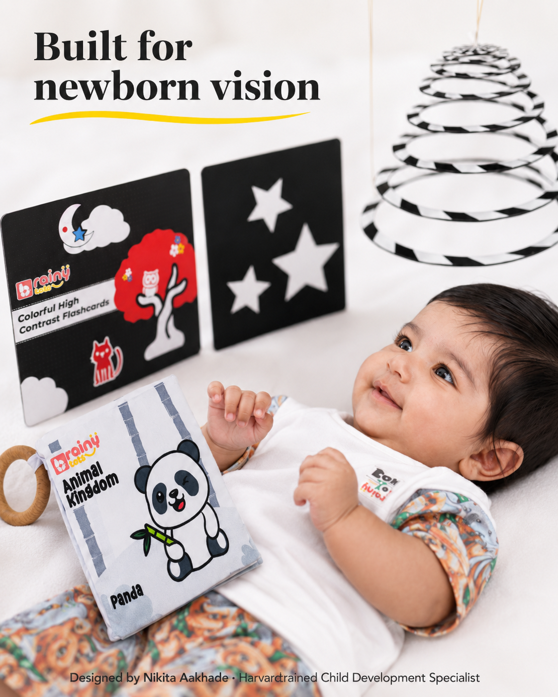 BrainyTots newborn visual development toys including a high-contrast hanging mobile, black and white flashcards, and cloth book.