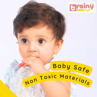 Baby holding a wooden peg from the BrainyTots Numbers Peg Board, highlighting the toy's baby-safe and non-toxic materials.