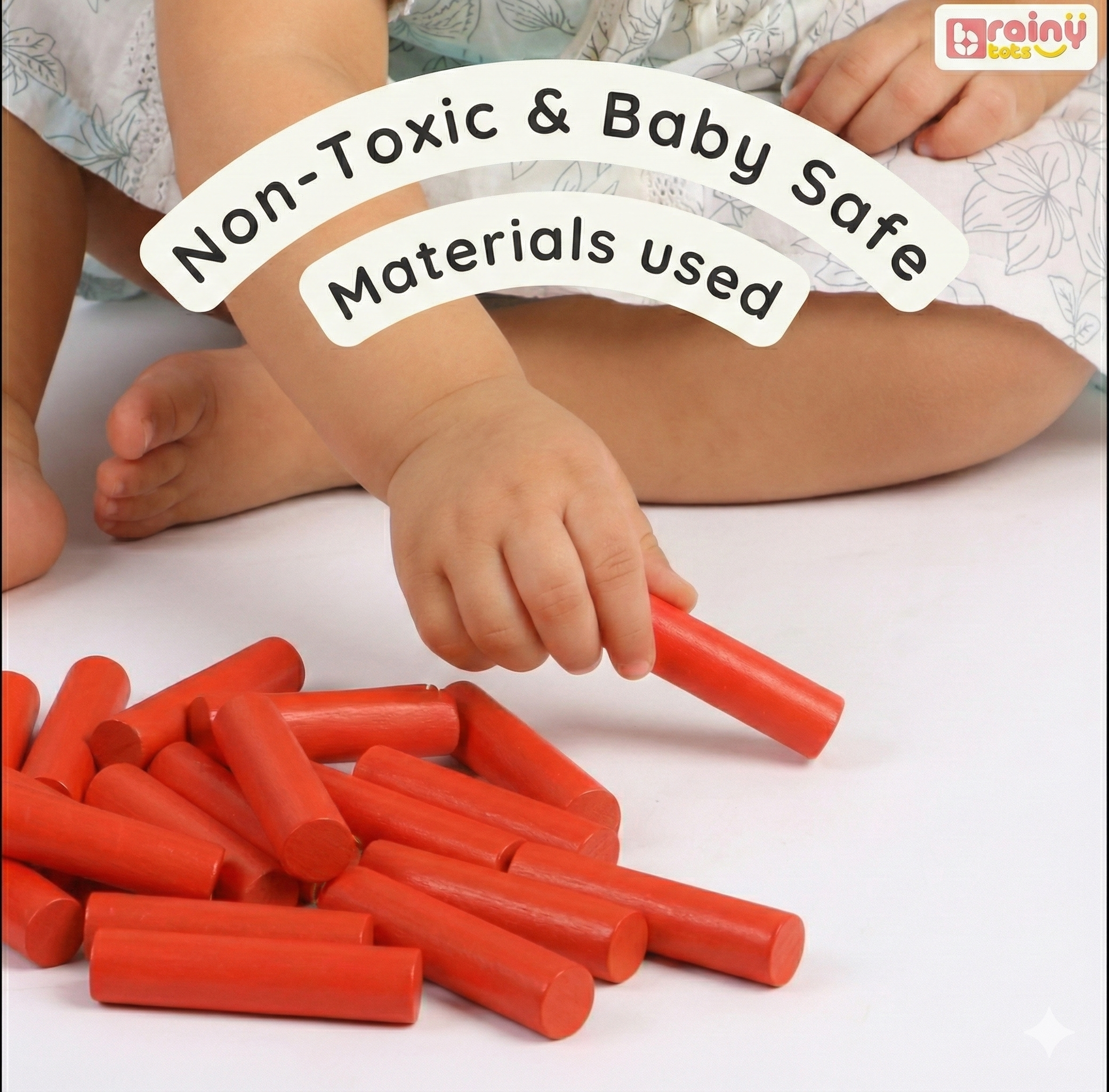 Child playing with red building blocks on a white surface, with text indicating non-toxic and baby-safe materials.