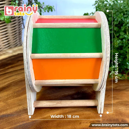BrainyTots Rainbow Spinning Wheel Montessori toy showing product dimensions of 18 cm width and 16 cm height, featuring colorful rotating panels, mirror, and baby-safe wooden construction for tummy time and sensory play.