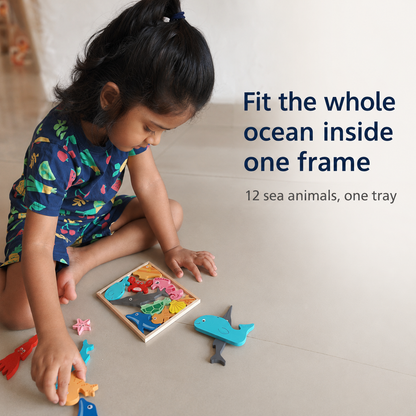 Child using the BrainyTots Montessori Sea Animals Square Puzzle to fit 12 wooden ocean animal pieces into one square tray, encouraging spatial reasoning, logical thinking, problem solving, and fine motor development through Montessori-inspired play.