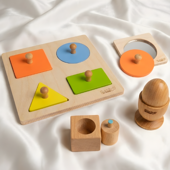 BrainyTots Shapes & Grasp Discovery Kit featuring a 4 Shapes Puzzle, Circle Shape Puzzle with Mirror, Pincer Cylindrical Puzzle, and Egg & Cup Montessori Puzzle. Designed for babies aged 6–24 months to develop fine motor skills, pincer grip, hand-eye coordination, shape recognition, problem-solving, concentration, and independent Montessori learning through natural wooden play.