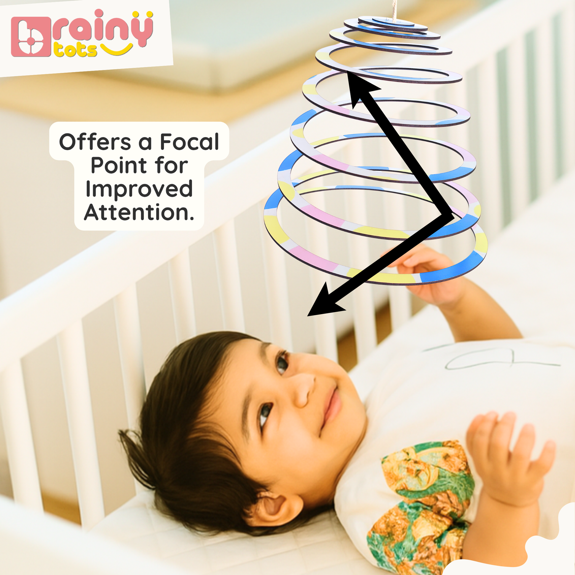 Baby visually tracking the BrainyTots Spiral Hanging Mobile as it gently spins above the crib, encouraging visual tracking, attention span, concentration, and focus. This Montessori-inspired natural wooden baby mobile provides a calming focal point for newborns and babies aged 0–12 months while supporting healthy visual and cognitive development.