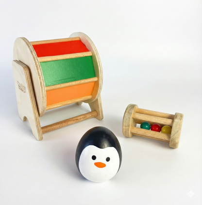 BrainyTots Tummy Time Discovery Kit featuring a Montessori wooden spinning wheel, rolling drum rattle, and balancing wobbler designed to encourage tummy time, sensory play, and early motor skill development for babies aged 3–12 months.