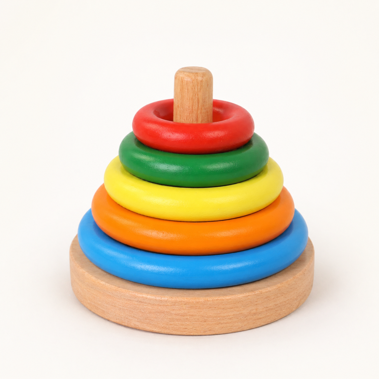 BrainyTots Wooden Ring Stacker Montessori toy with colorful stacking rings made from natural wood, designed for babies aged 6+ months to develop fine motor skills, hand-eye coordination, color recognition, size sequencing, problem-solving, and independent learning through self-directed play.