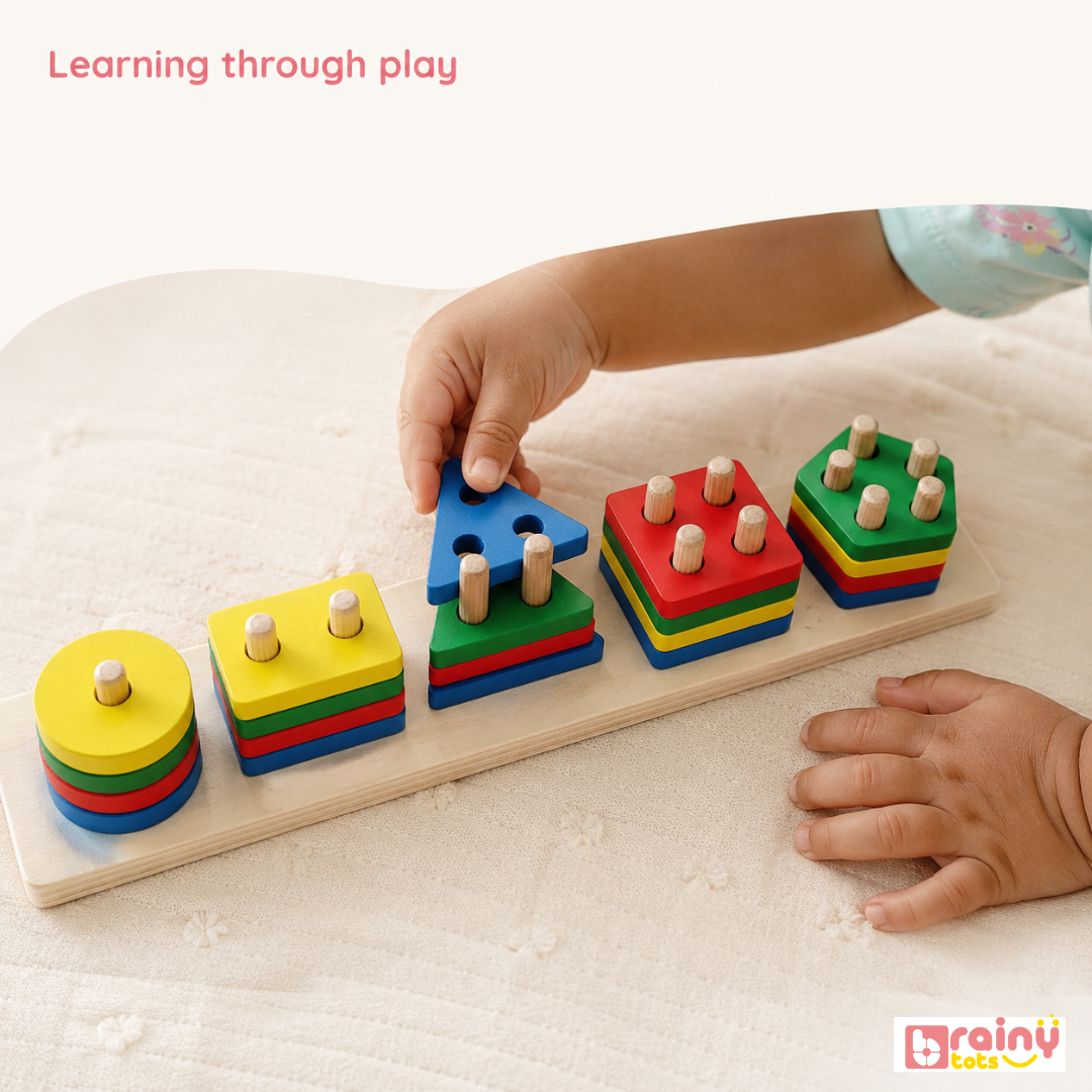 Toddler using the BrainyTots wooden shape sorting board to stack colourful geometric pieces during hands-on play.