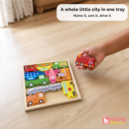 Toddler holding a wooden fire engine from the BrainyTots vehicle puzzle while exploring and naming different vehicles.