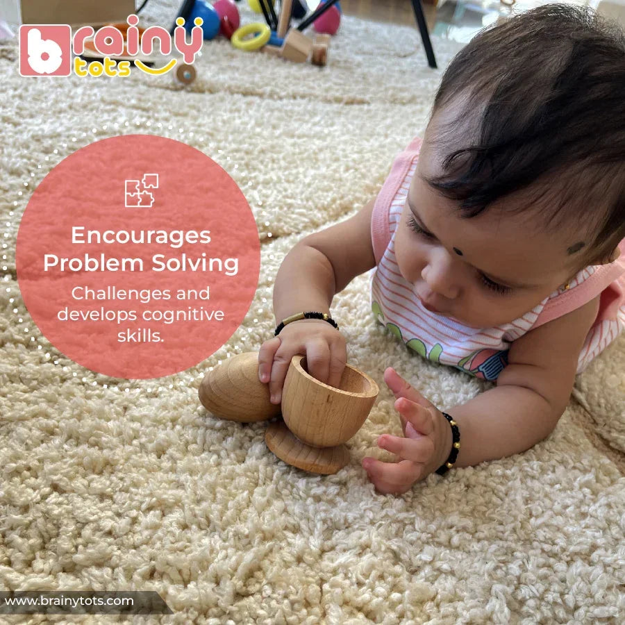 Baby on tummy reaching into a natural wooden Montessori egg and cup puzzle cup piece with focused curiosity, the egg resting nearby on a soft rug, encouraging problem solving and cognitive skill development for infants 6–15 months.