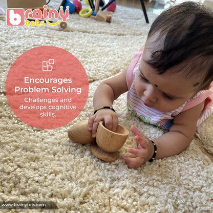 Baby on tummy reaching into a natural wooden Montessori egg and cup puzzle cup piece with focused curiosity, the egg resting nearby on a soft rug, encouraging problem solving and cognitive skill development for infants 6–15 months.