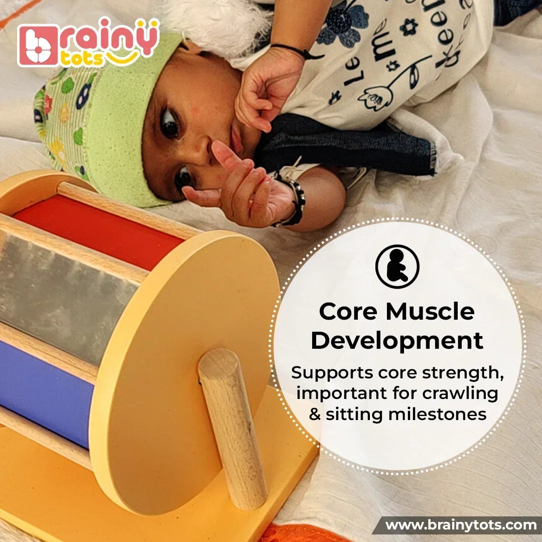 Baby engaging with the BrainyTots Montessori Rainbow Spinning Wheel during tummy time to strengthen core muscles, improve neck control, and support crawling and sitting milestones for babies aged 3–12 months.
