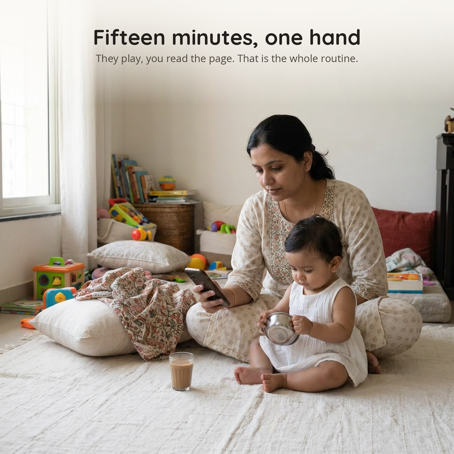 A mother reads the day's page while her baby plays