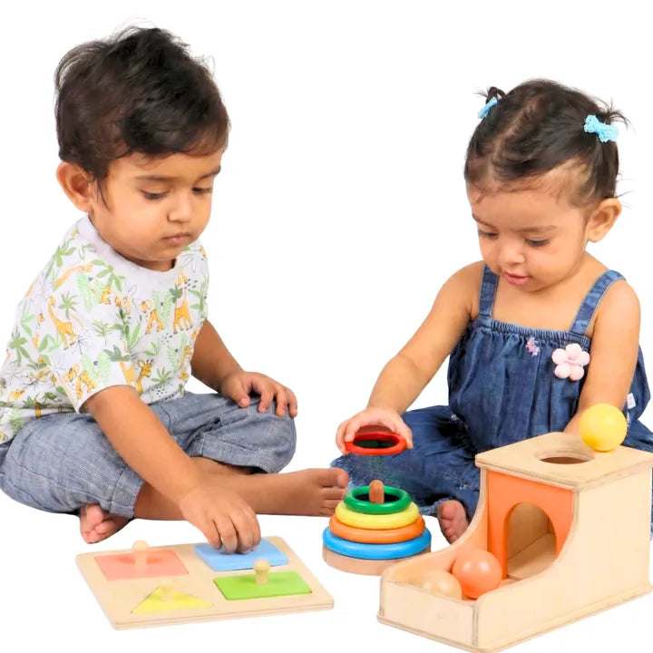 Two toddlers playing with the problem-solving kit
